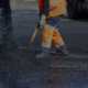 Side view of man asphalt paving