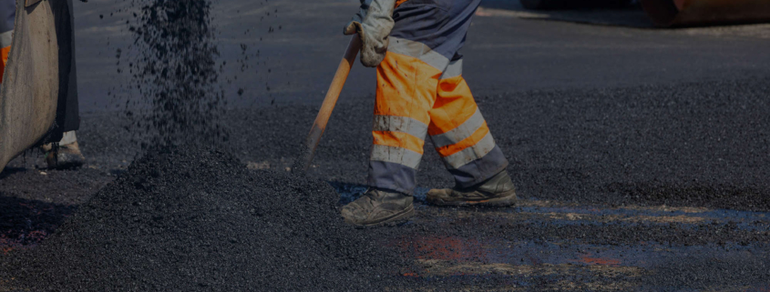 Side view of man asphalt paving