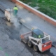 Two small milling asphalt machine driven by a worker in a street