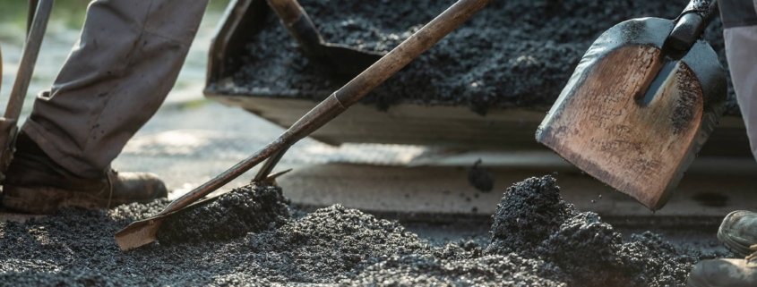 Workers making new asphalt pavement