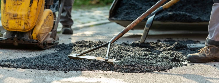 Workers repairing asphalt