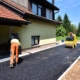 Worker Applying Asaphalt To Residential Drivewy