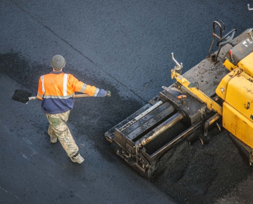 Workers Lay A New Asphalt Coating Using Hot Bitumen