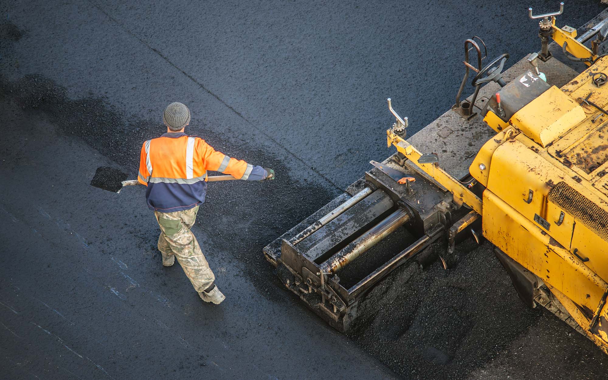 Workers Lay A New Asphalt Coating Using Hot Bitumen