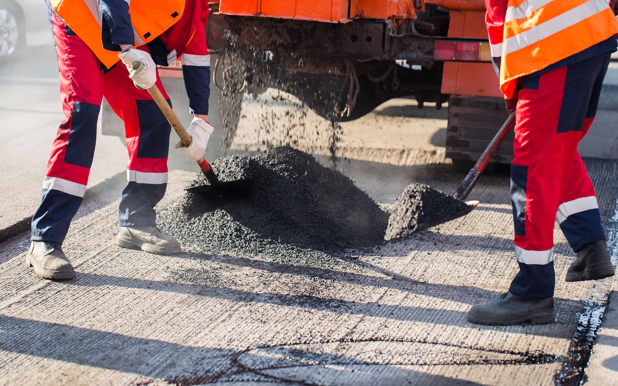Young Builder On Asphalting Paver Machine During Road Street Repairing Works