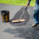 Worker Sealing Driveway