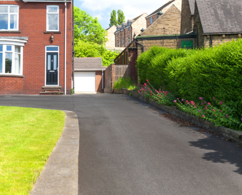 Typical English Single Family House Built Of Red Bricks, With A Large Driveway